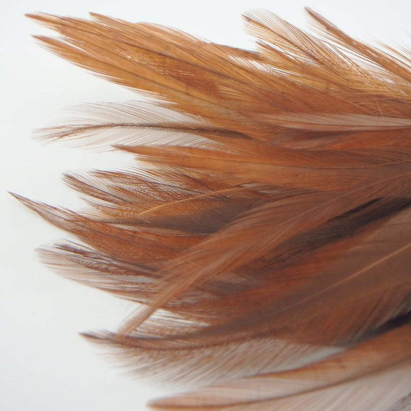 Brown Fish Hunter Saddle Hackle – natural brown feathers for tying realistic streamers, craw patterns, and classic leech patterns.