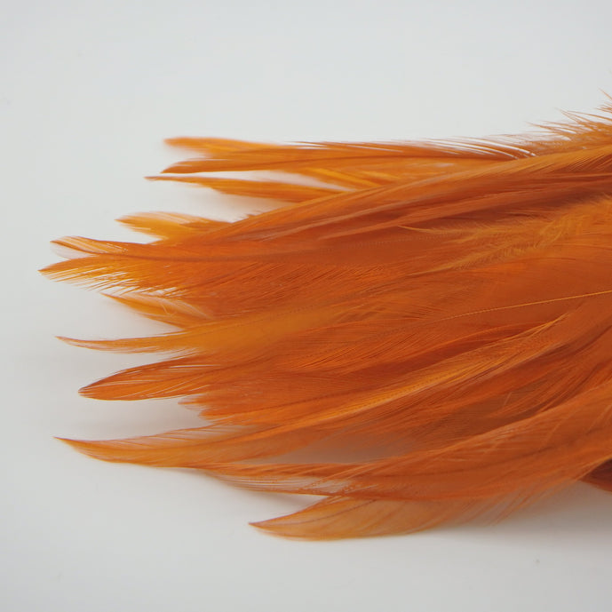 Crawfish Orange UV Fish Hunter Saddle Hackle – UV-reactive orange hackle feathers ideal for crayfish patterns, streamers, and warmwater attractor flies.