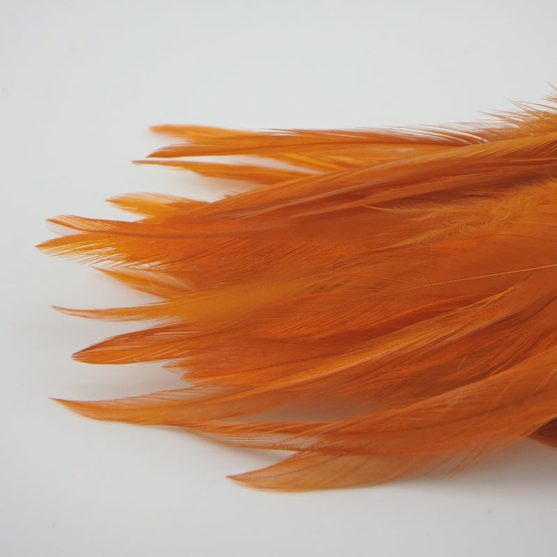 Crawfish Orange UV Fish Hunter Saddle Hackle – UV-reactive orange hackle feathers ideal for crayfish patterns, streamers, and warmwater attractor flies.