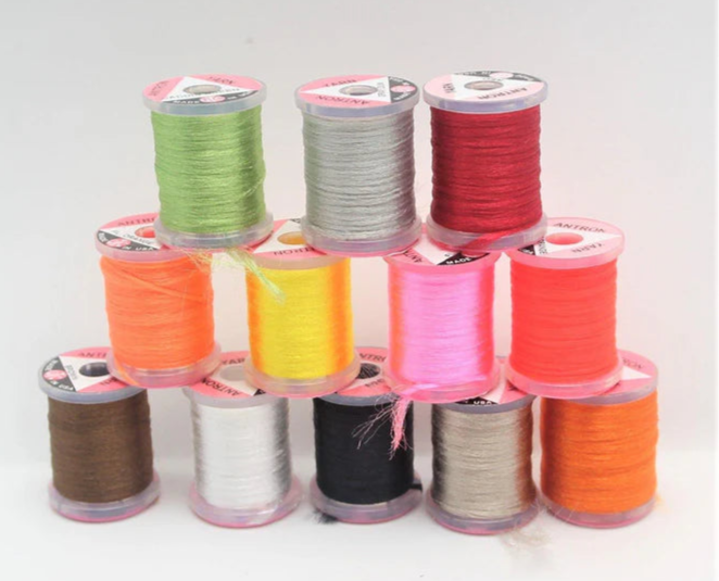 Spool of UTC Antron Yarn in synthetic trilobal fiber, ideal for wing posts, shucks, and dry fly bodies.